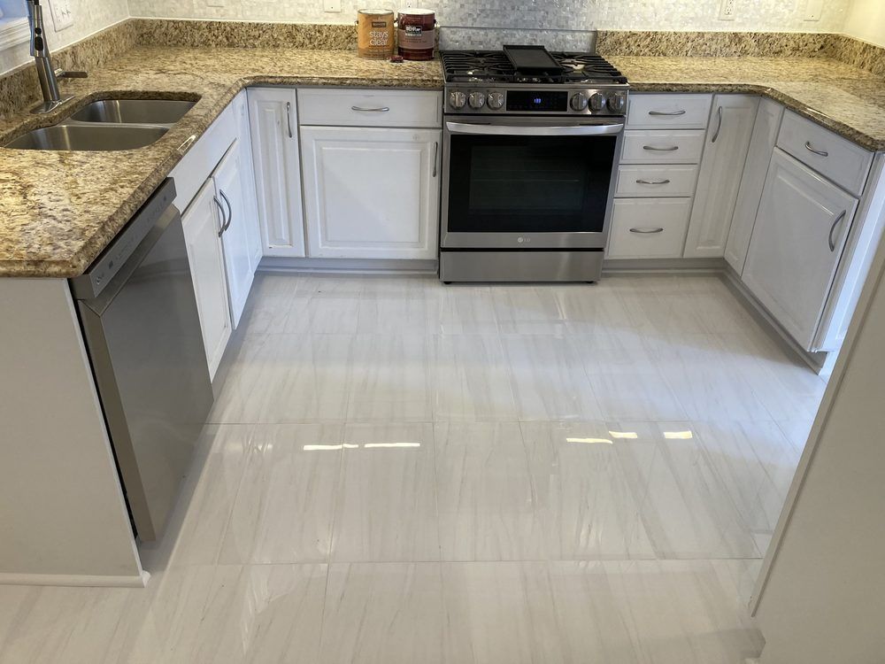 A kitchen with a stove , sink , and dishwasher