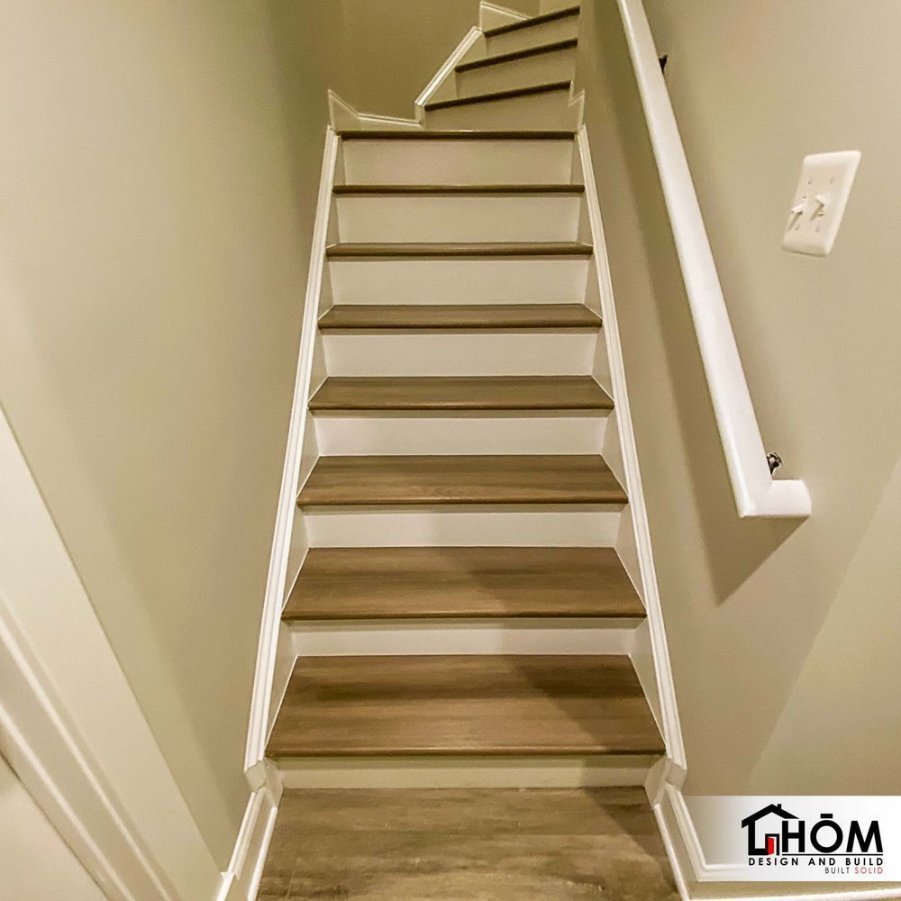 A staircase with wooden steps and a white railing