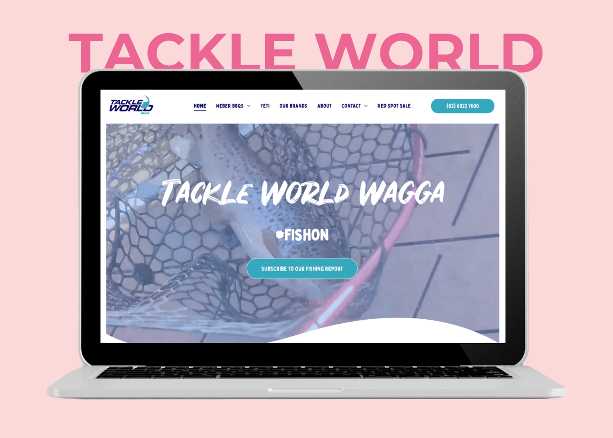 A laptop displaying the Tackle World Wagga website homepage on a pale pink background.