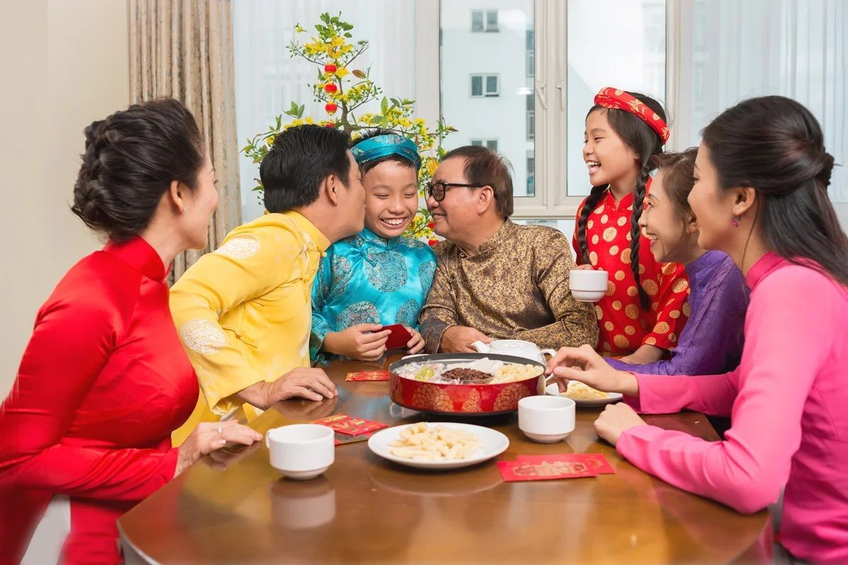 Vietnamese people enjoying Tet holidays with family in Vietnam