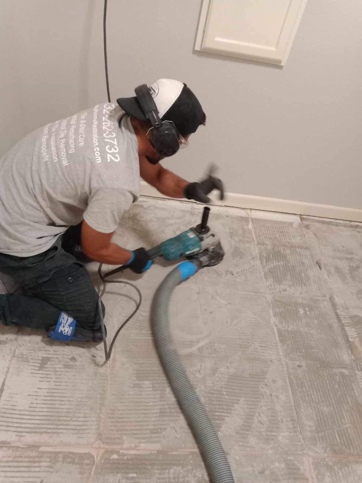 Re-Nu Tile and grout technician grinding the concrete slab to remove tile thinset before setting tile.