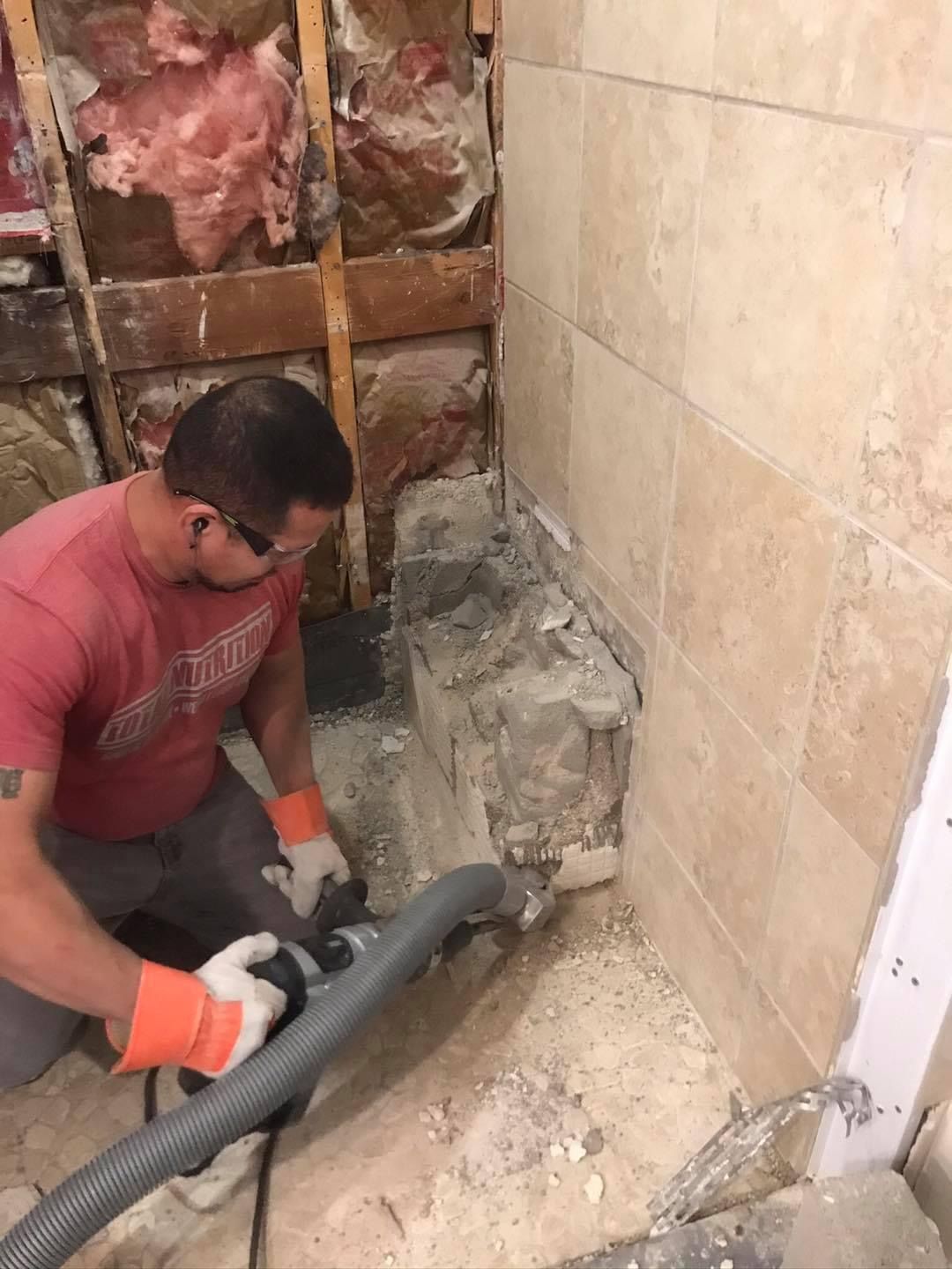 Demolition of a shower bench using duct collection equioment.