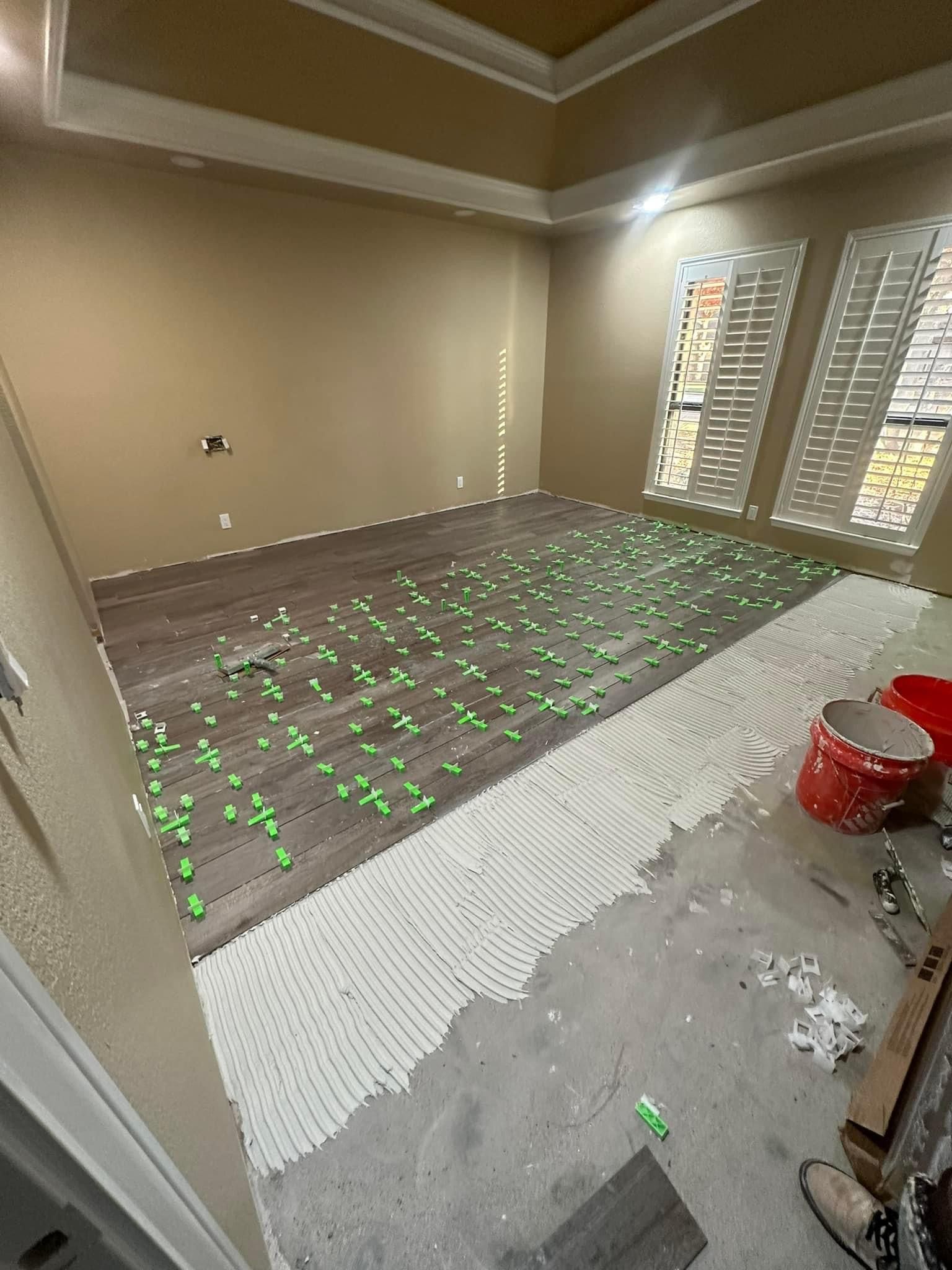 wood plank tile being installed using leveling clip to reduce tile lippage. 