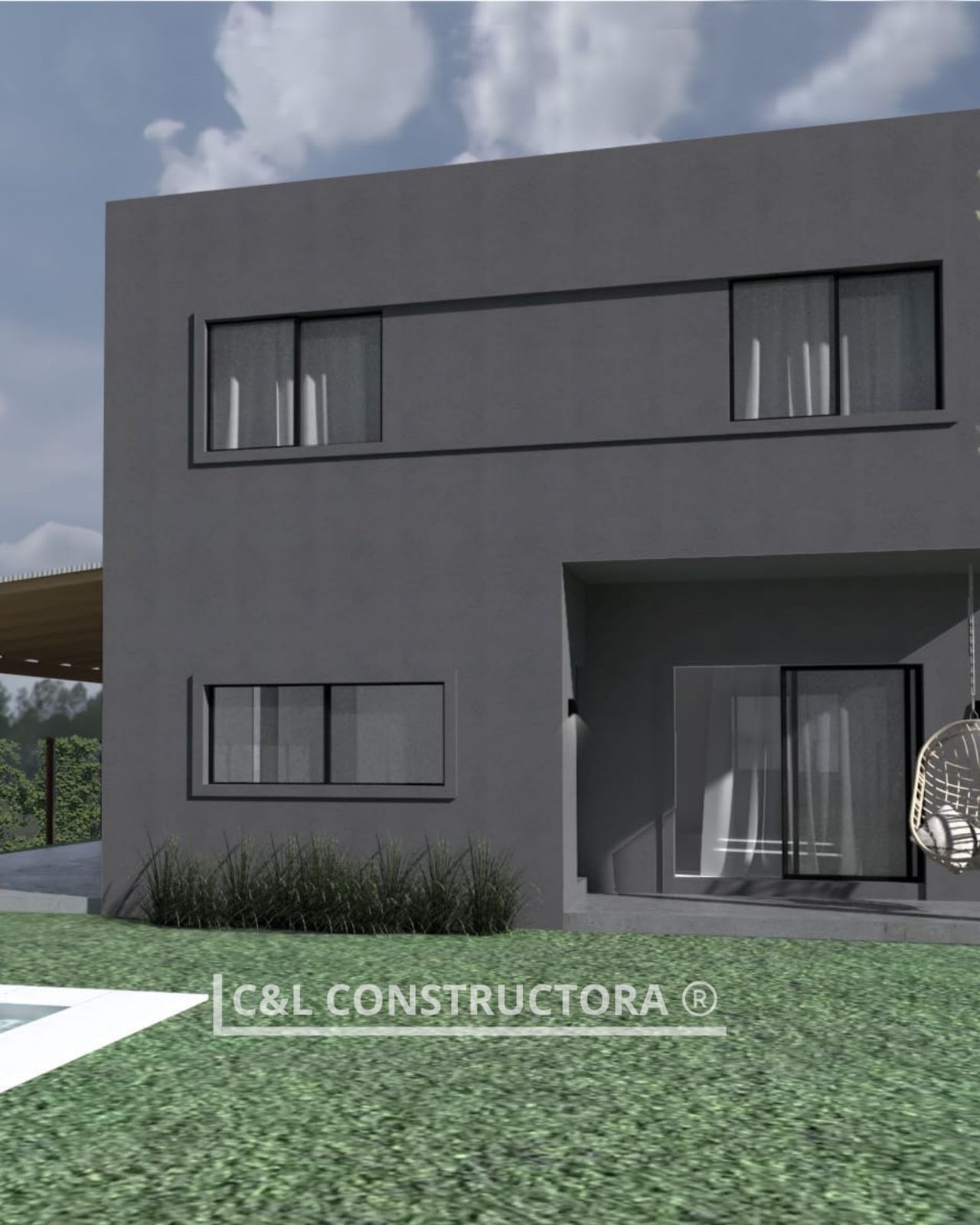 Edificio moderno de dos plantas de color gris, con ventanas rectangulares y patio exterior cubierto.