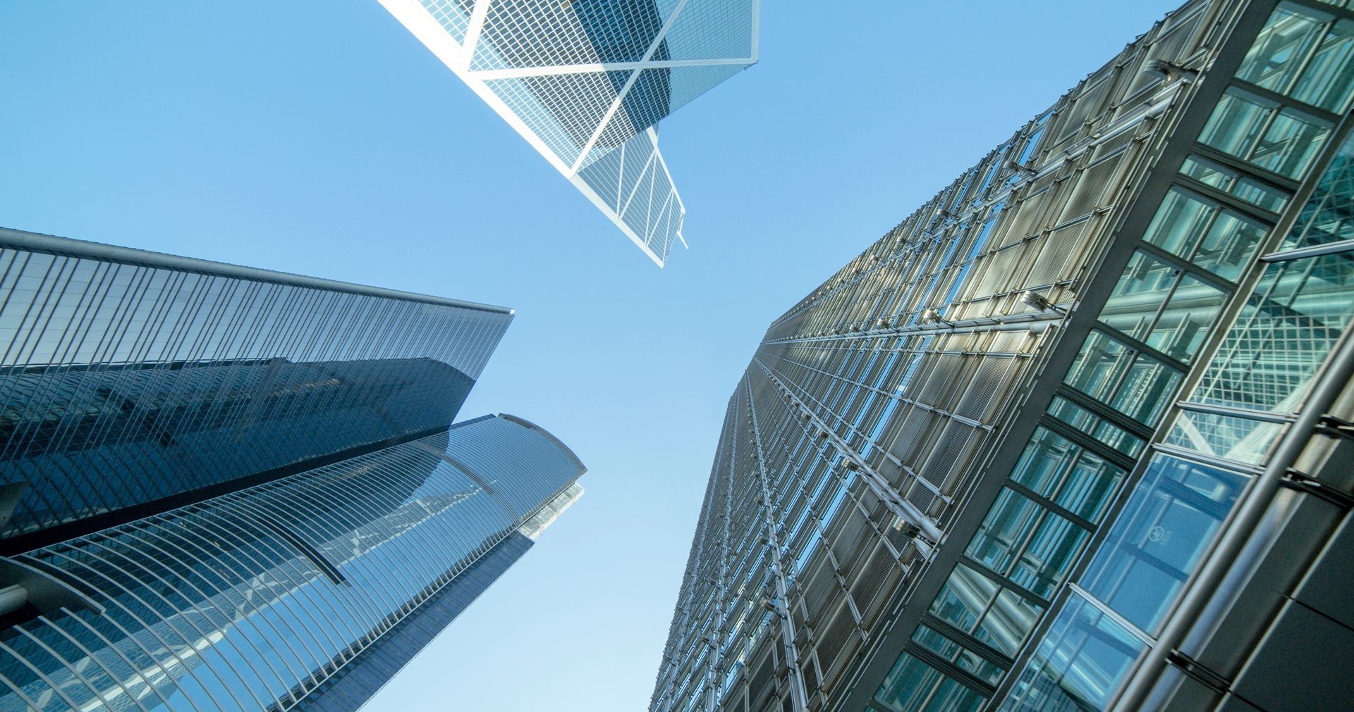 Looking up at a tall building with a blue sky in the background