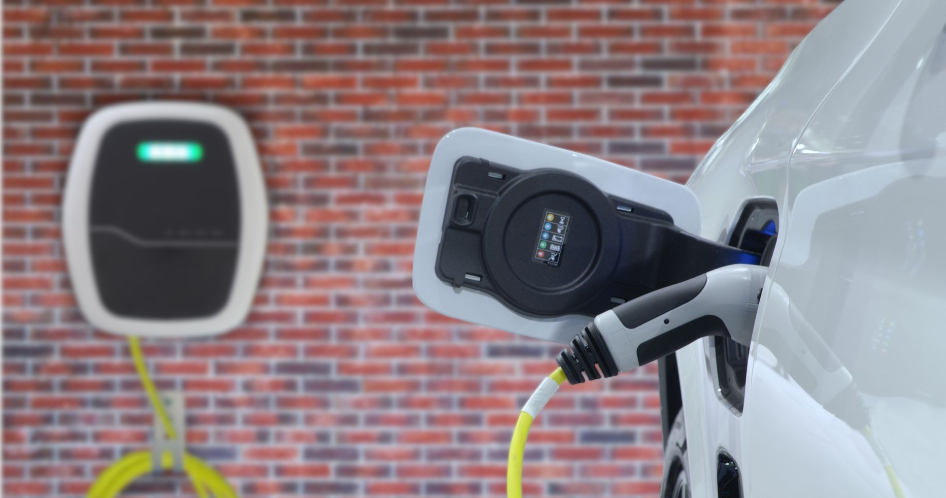 An electric car is being charged at a charging station.