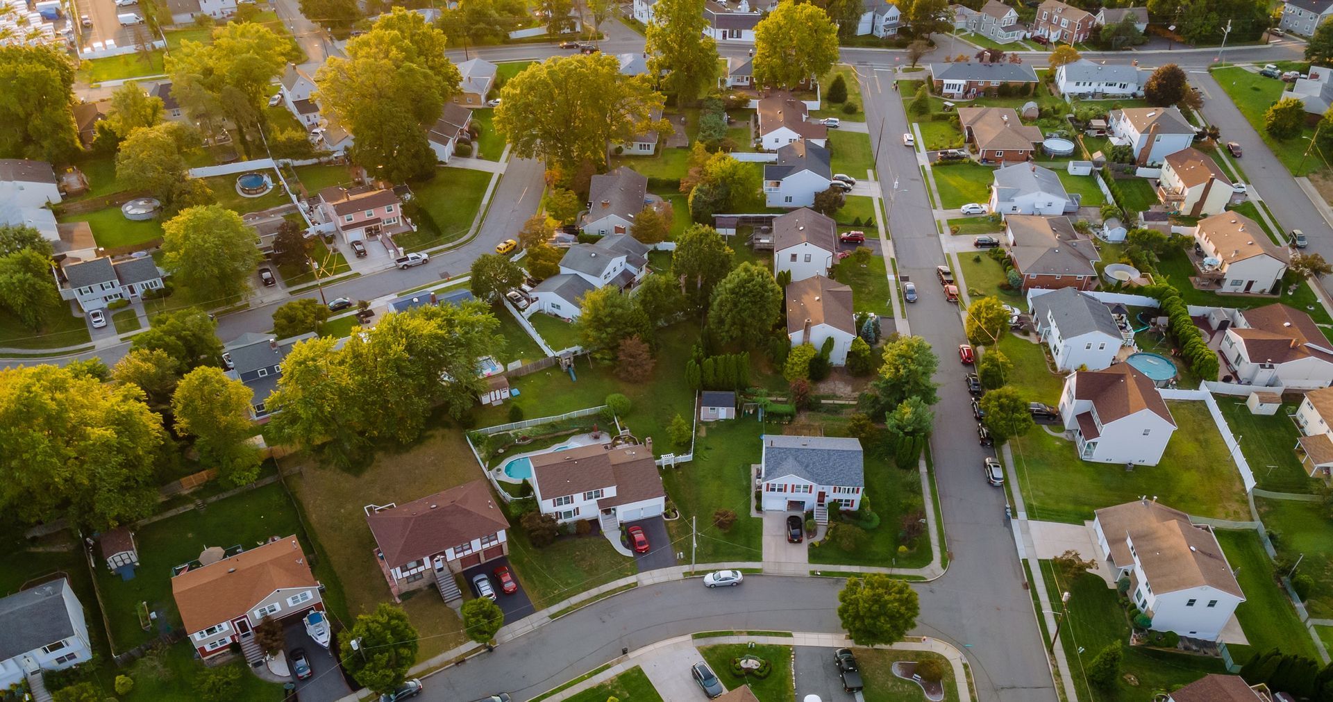 An aerial view of a residential neighborhood with lots of houses and trees.