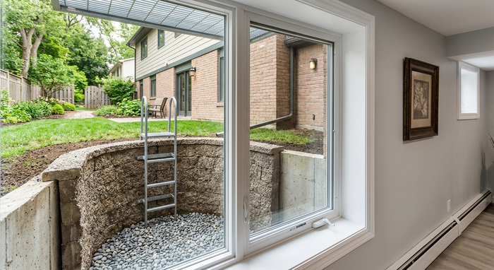 Looking from the interior of a home to the outside with a new egress window well installed to meet bozeman and Gallatin County building requirements in Montana