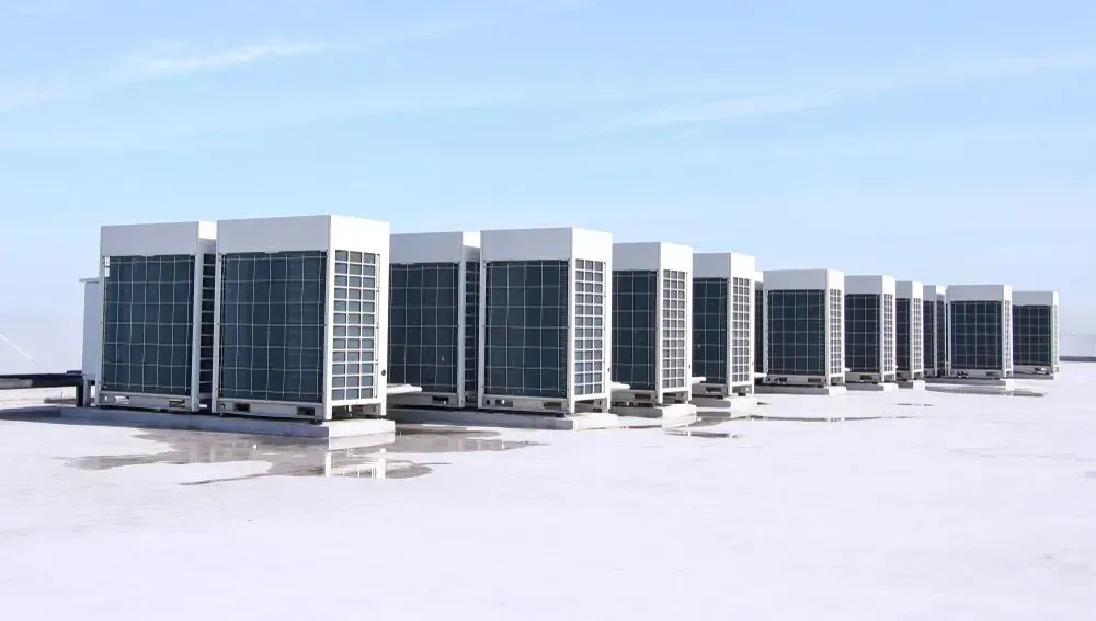 A Row of Large Industrial Air Conditioning Units on a White — CH Electrics in Yeppoon, QLD