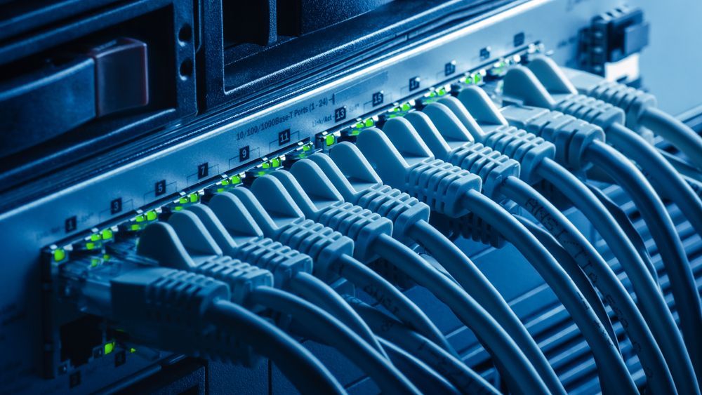 A Network Switch With Multiple Ethernet Cables Plugged Into Its Ports — CH Electrics in Emerald, QLD