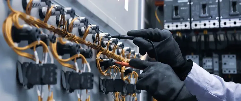 Gloved Hands Using Test Probes on Electrical Components Inside a Control Panel — CH Electrics in Rockhampton, QLD