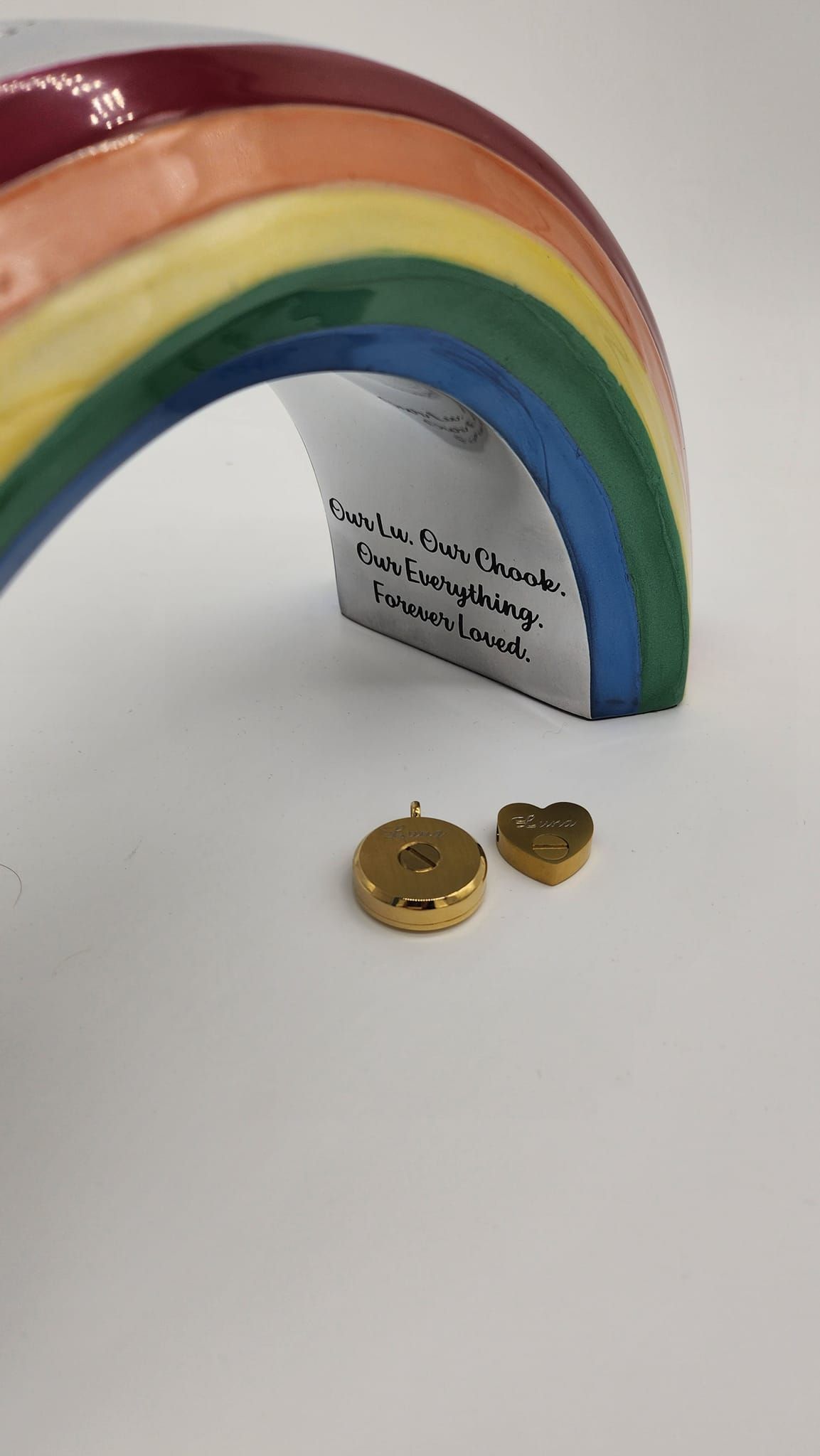 Ceramic Rainbow With Gold Heart and Circle Charms on White Background — Furever Pet Cremations in Rockhampton, QLD