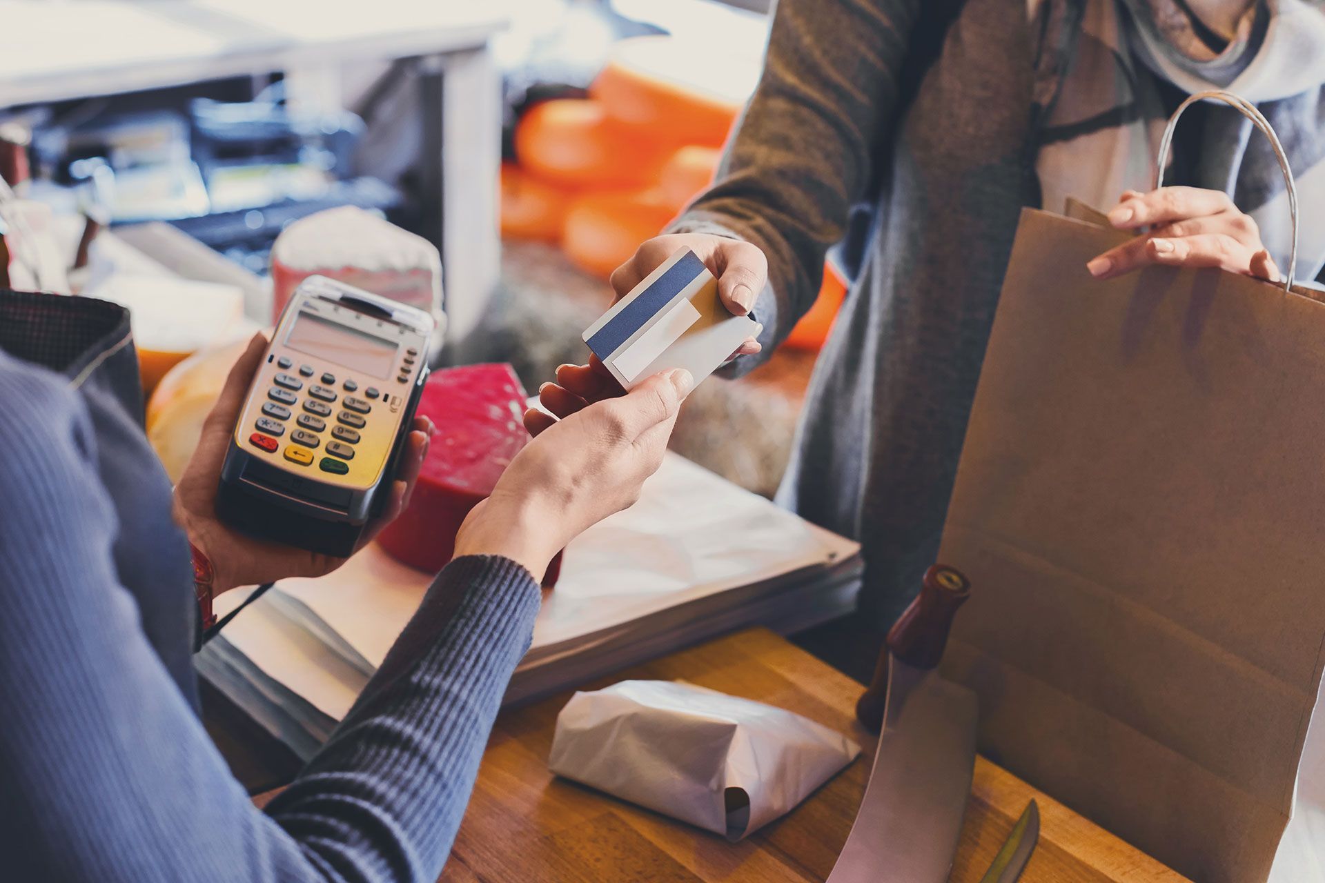 A woman is paying with a credit card in a restaurant.