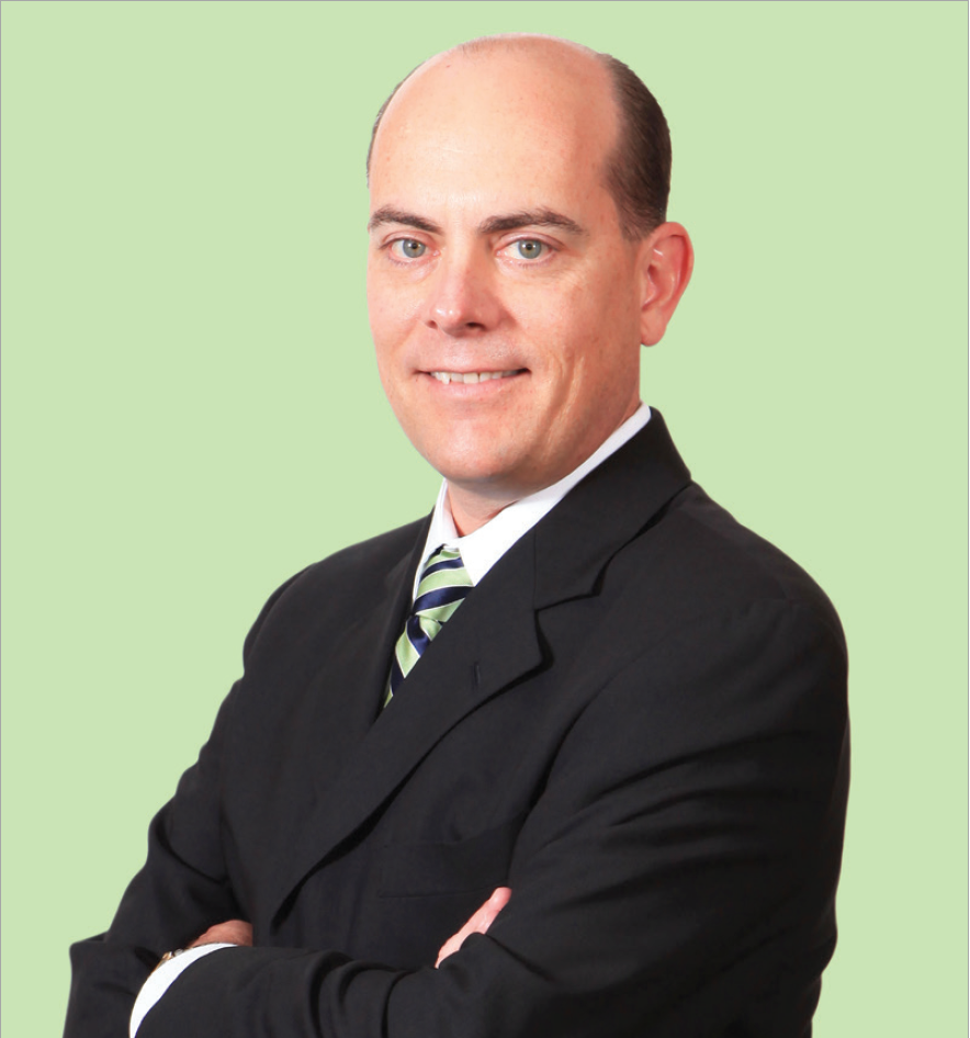 JimGowen A man in a suit and tie with his arms crossed