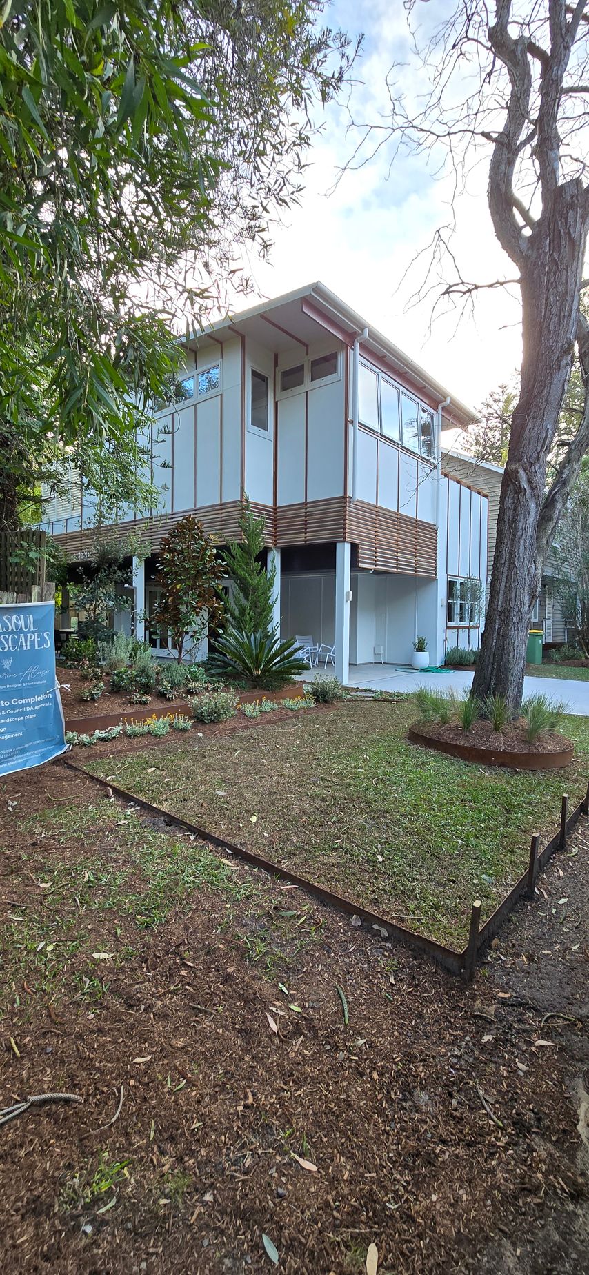 An empty room with a bucket of paint and a paint roller — JAX Painting Services in Central Coast, NSW