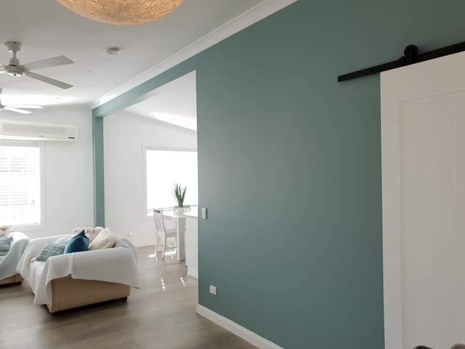 A Living Room With a Couch and a Ceiling Fan — JAX Painting Services in Central Coast, NSW