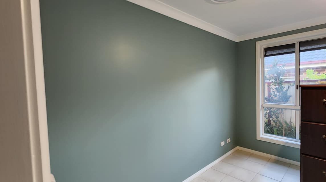 A living room with a lot of windows and a fireplace — JAX Painting Services in Central Coast, NSW