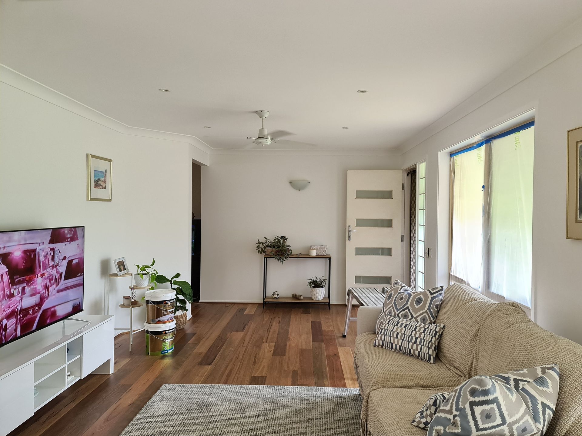 An Empty Bedroom With a Bed and a Ceiling Fan — JAX Painting Services in Central Coast, NSW