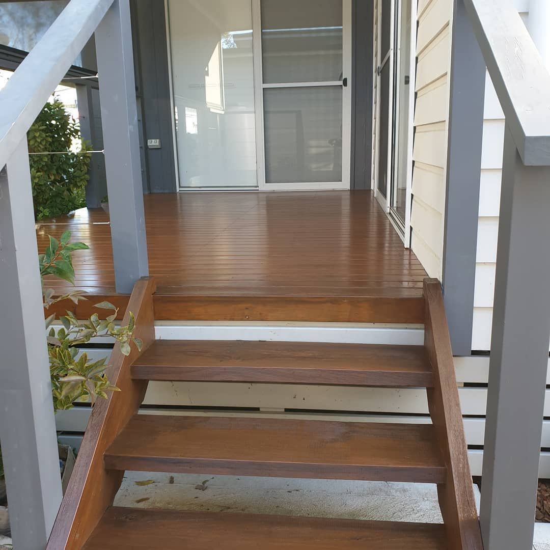 A Wooden Deck With Stairs Leading Up to It — JAX Painting Services in Central Coast, NSW