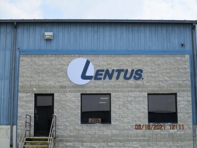 Centus warehouse exterior with blue metal siding and a concrete facade featuring a large logo. Centus warehouse exterior with blue metal siding and a concrete facade featuring a large logo.