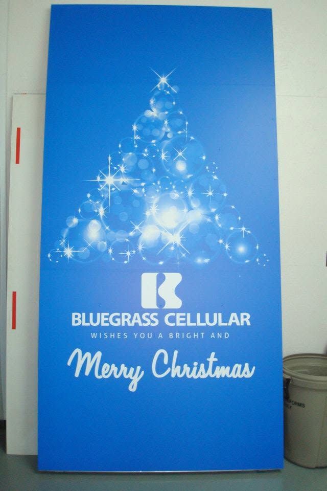 Blue Bluegrass Cellular holiday sign with sparkling Christmas tree and “Merry Christmas” text. Blue Bluegrass Cellular holiday sign with sparkling Christmas tree and “Merry Christmas” text.
