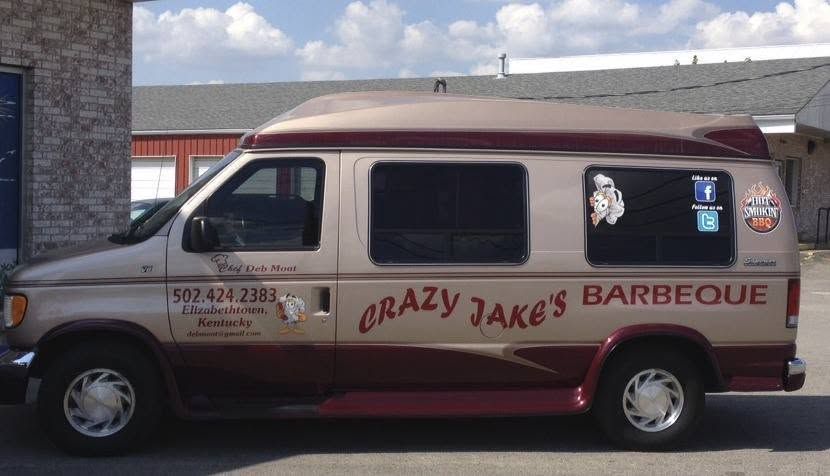 Brown-and-white barbecue catering van with “Crazy Jake’s Barbeque” painted on the side. Brown-and-white barbecue catering van with “Crazy Jake’s Barbeque” painted on the side.