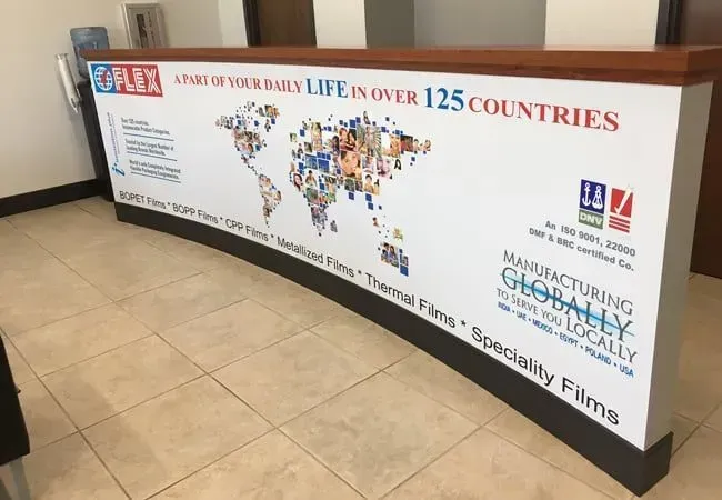 Large white and brown banner about life insurance and global coverage displayed indoors.