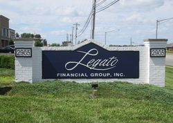 Leafo Financial Group, Inc. sign on a white brick monument by a roadside.