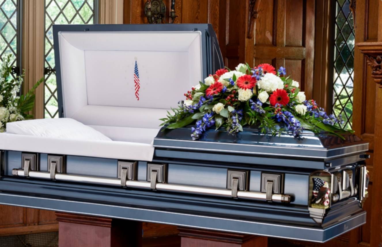 Polished wooden casket with a flower spray, one of the casket options in Provo, Utah