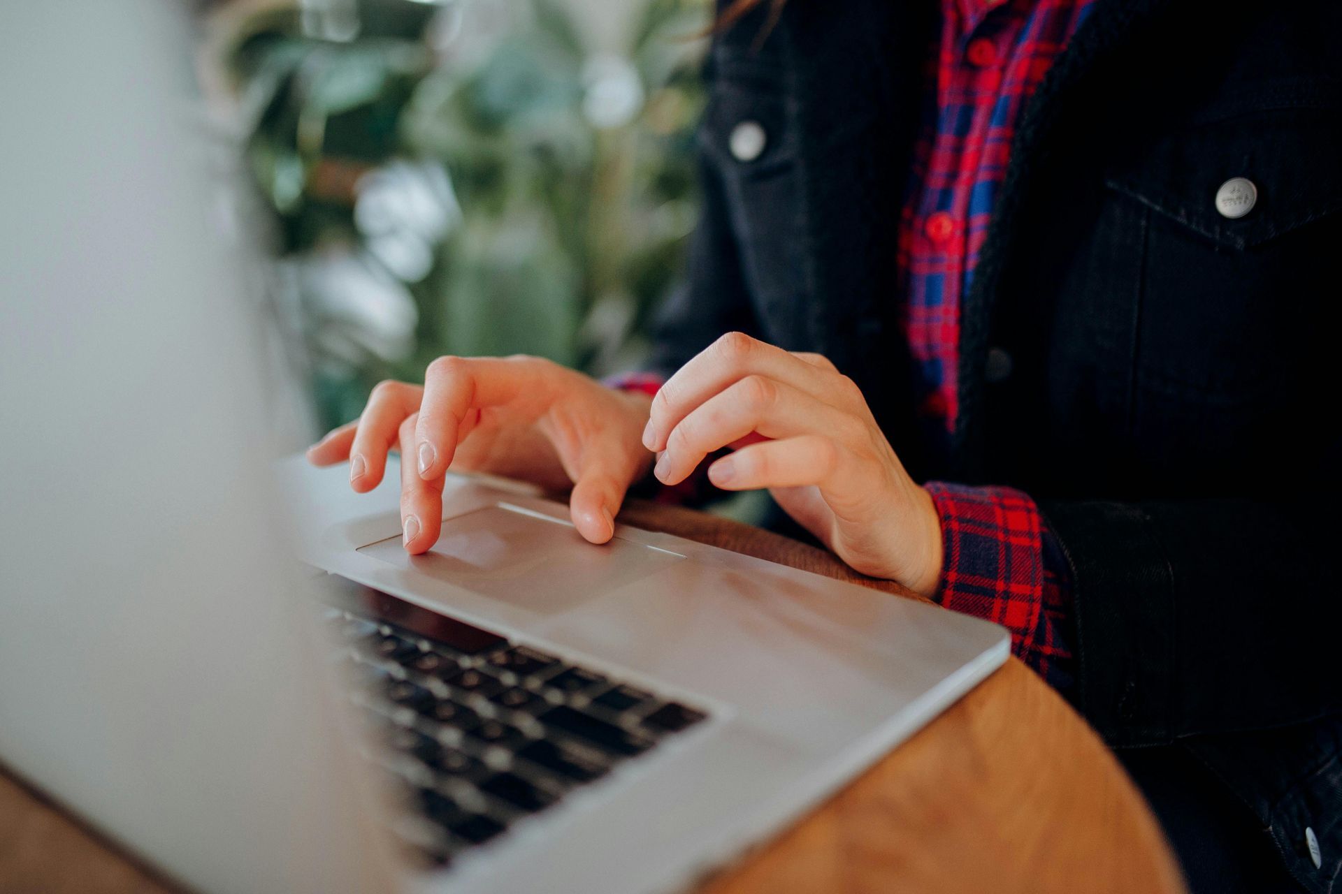 Person typing an obituary on a laptop