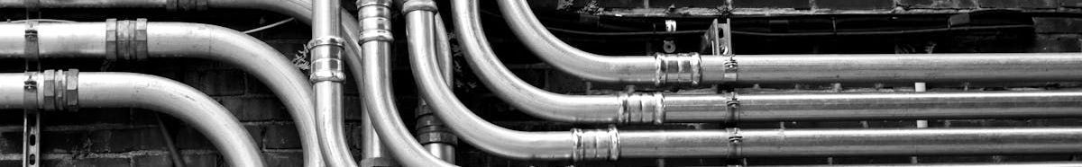 A black and white photo of a bunch of pipes connected to each other.