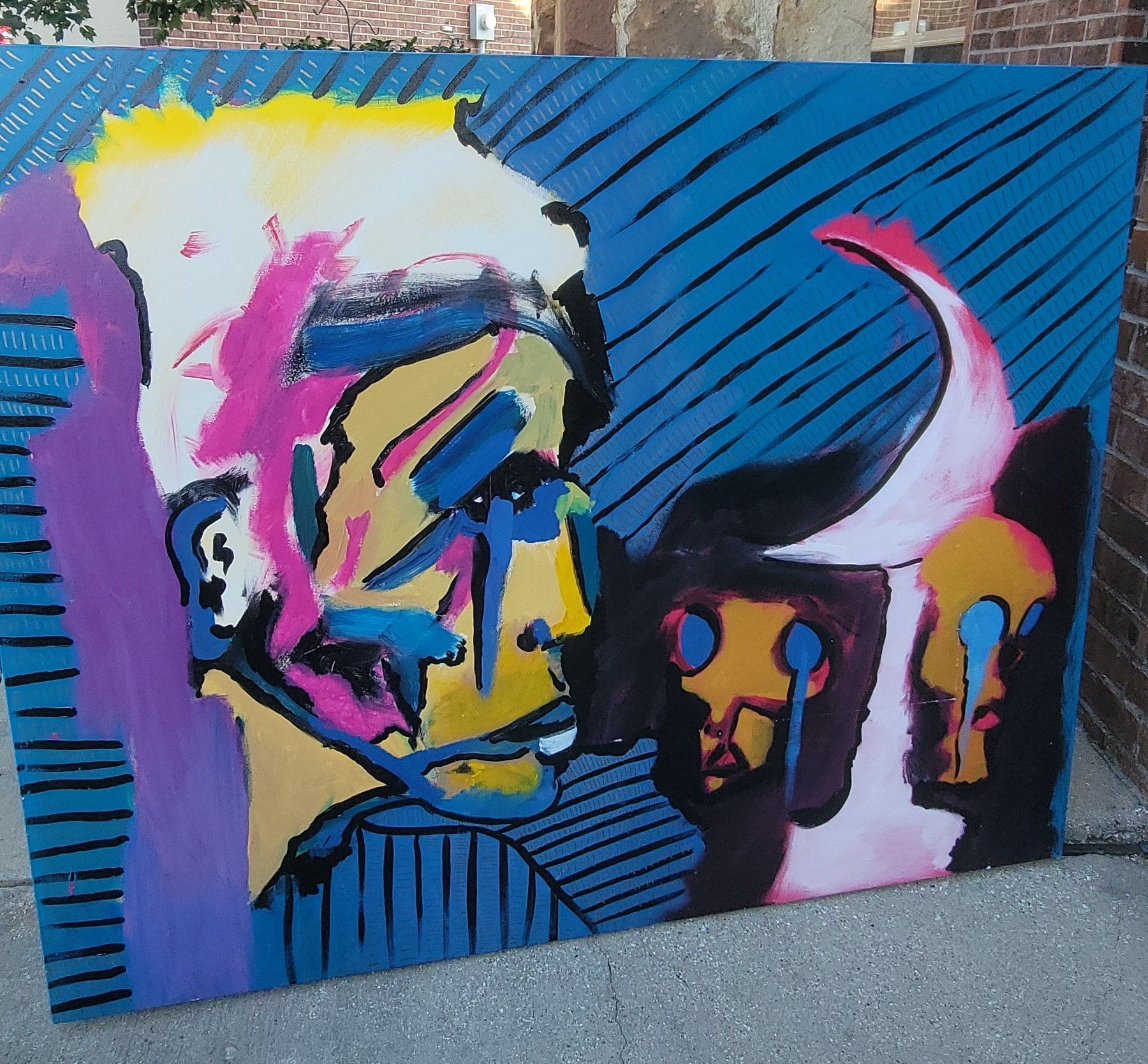 Painting of three abstract faces.