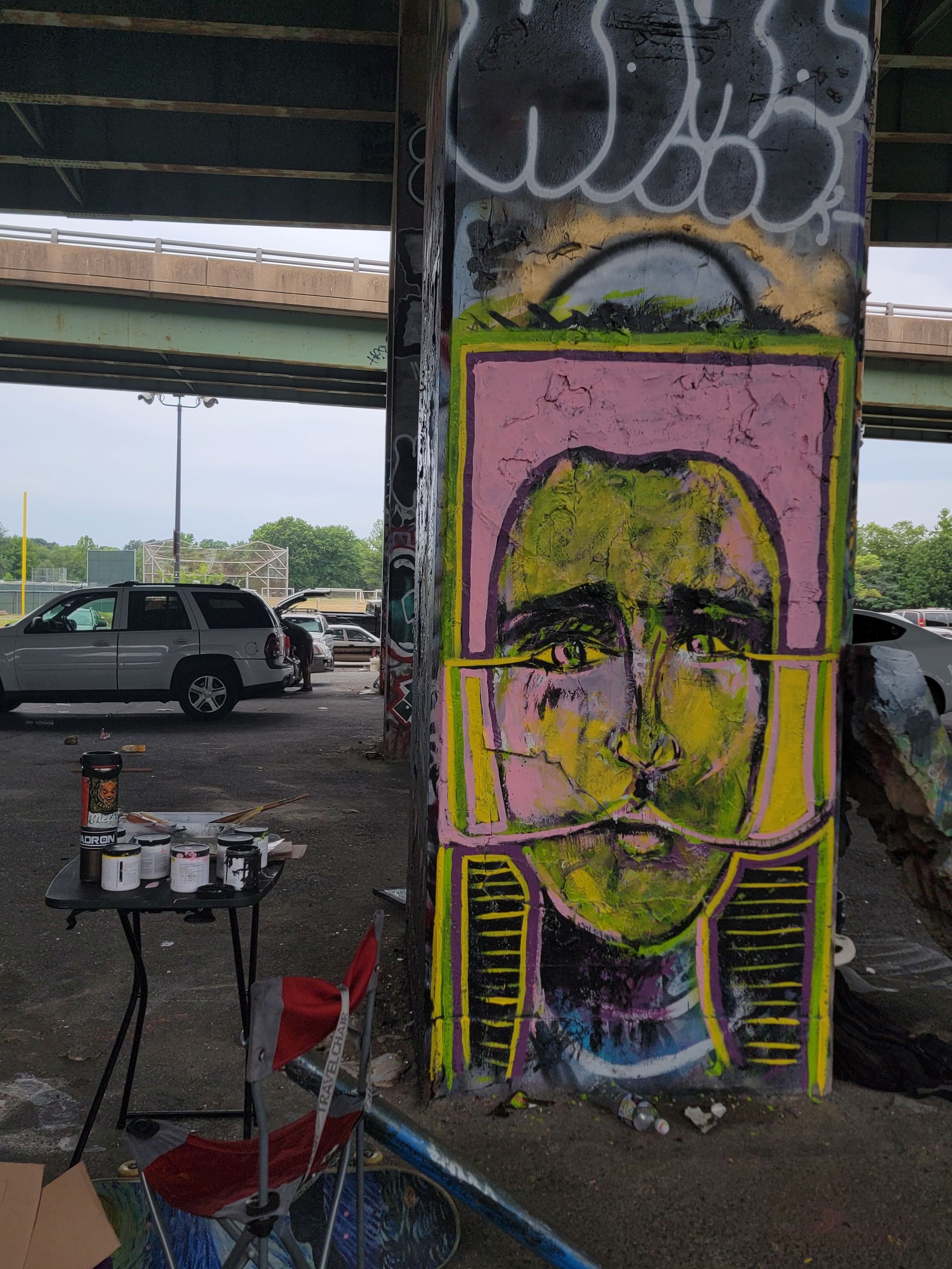 artwork painted with acrylic paint on the column of a bridge.
