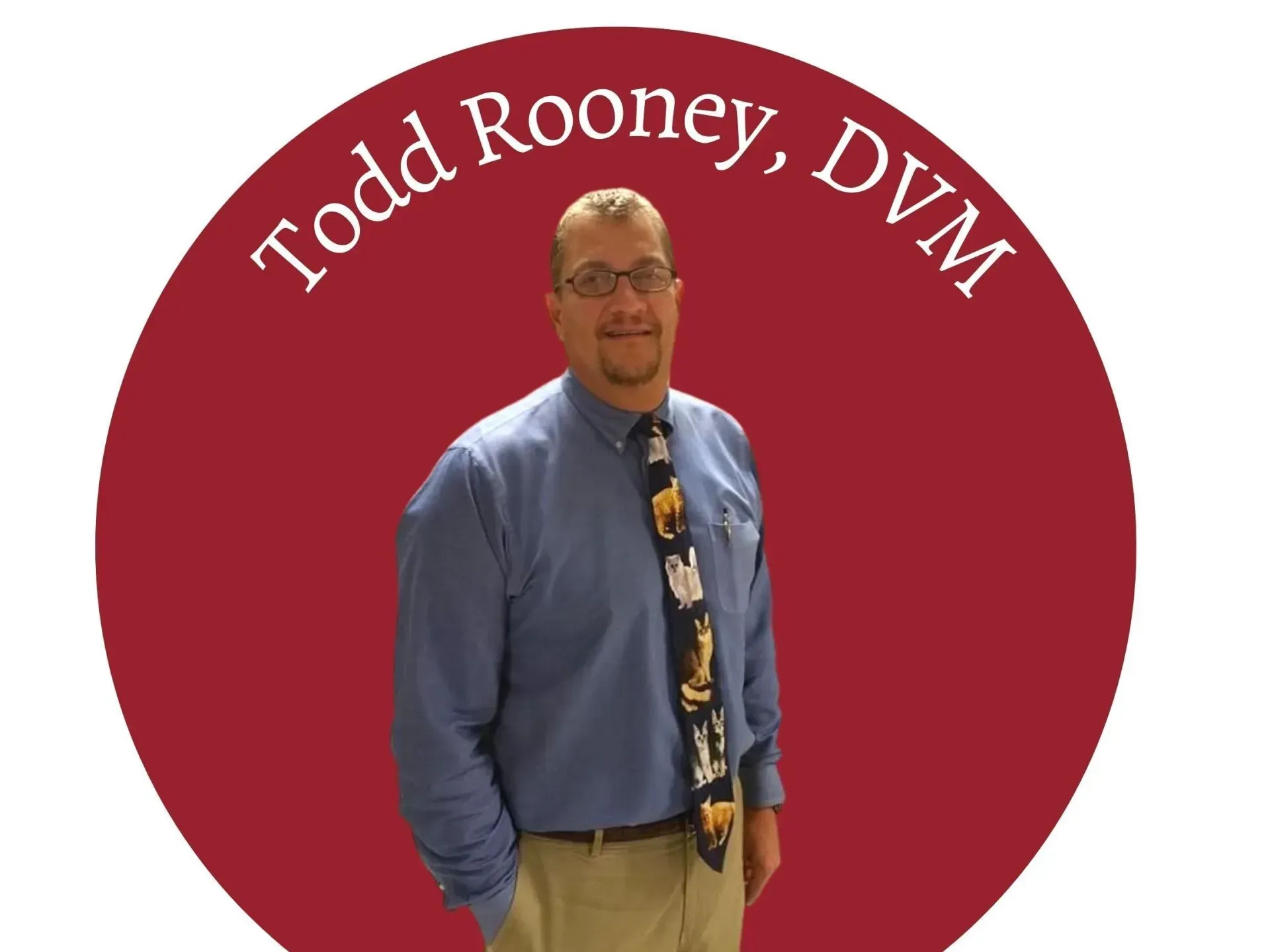 Todd Rooney, DVM, stands in front of a red circle. He wears a blue shirt and a tie with animal designs.