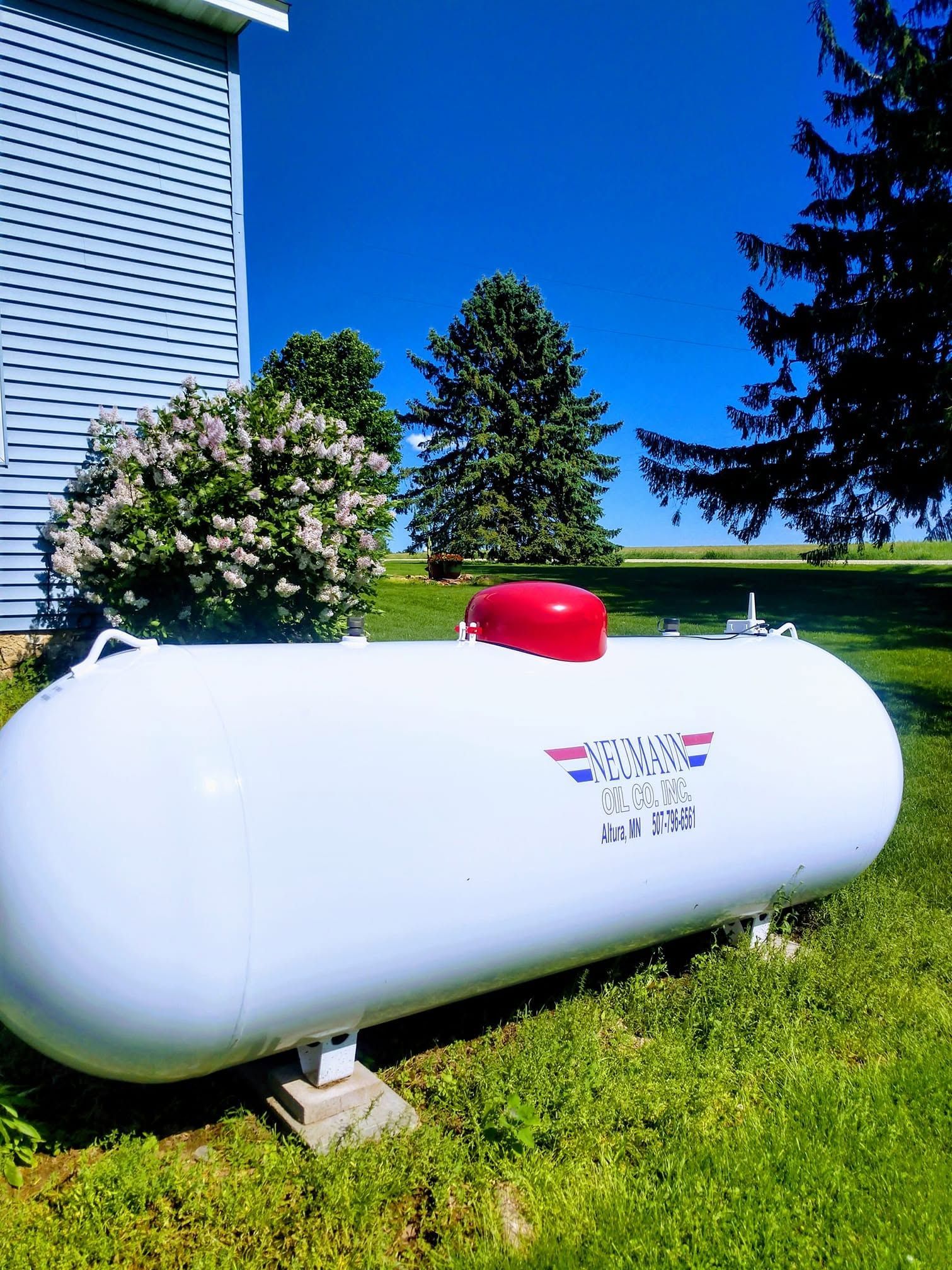 Neumann Oil Company propane tank in a rural residential lawn