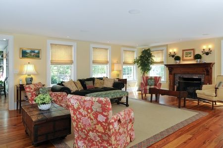 A living room with a couch and chairs and a fireplace