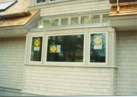 A house with a window that has a yellow sign on it