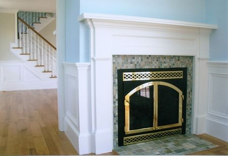 A fireplace with a staircase in the background