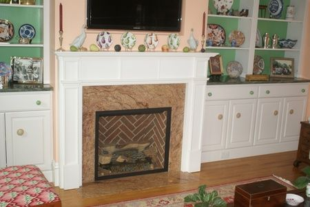 A living room with a fireplace and a flat screen tv