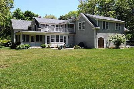 A large house with a large lawn in front of it.