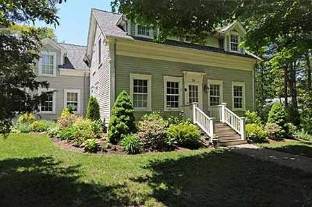 A large house with a lot of windows and stairs in front of it.