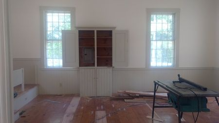 There is a table saw in the middle of the room.