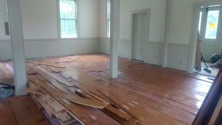 A room with wooden floors and white walls.