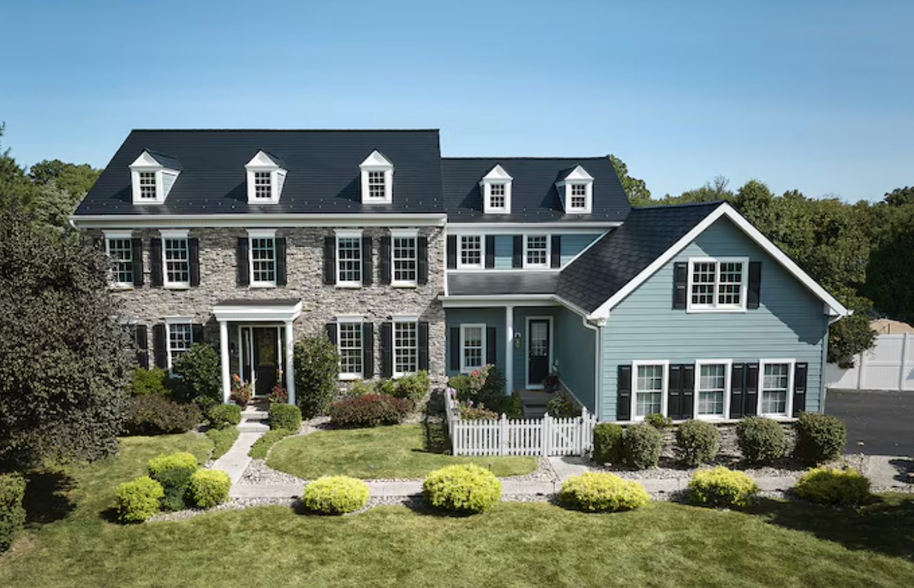 An aerial view of a large house and a smaller house.