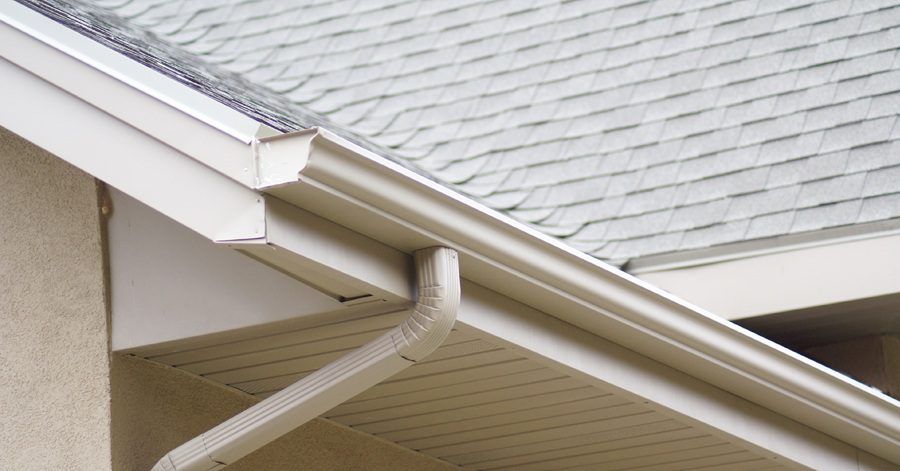 A close up of a gutter on a roof of a house
