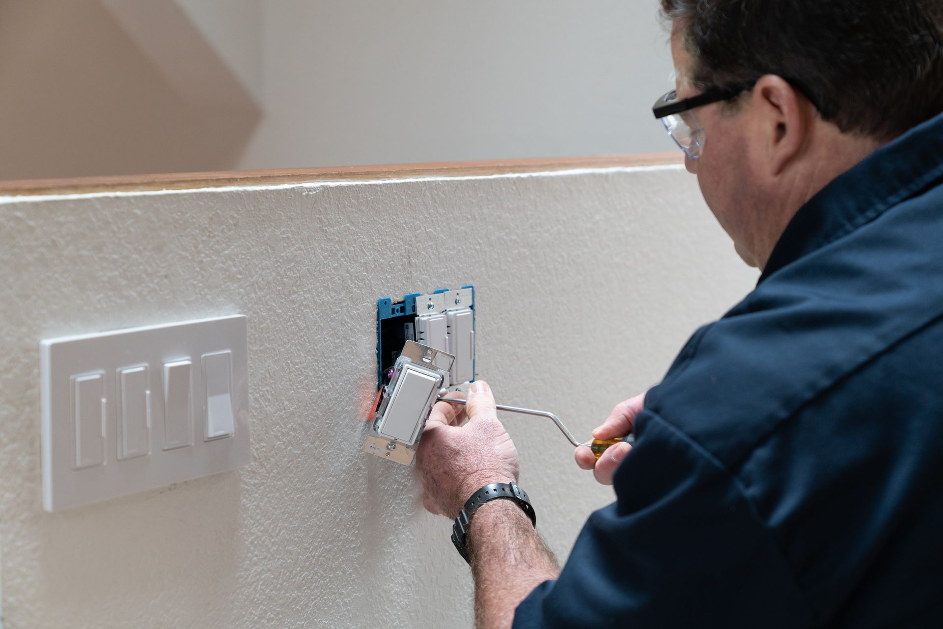 Electrician Installing Light Switch — Janesville, WI — Richter Electric Electrician Installing Light Switch — Janesville, WI — Richter Electric