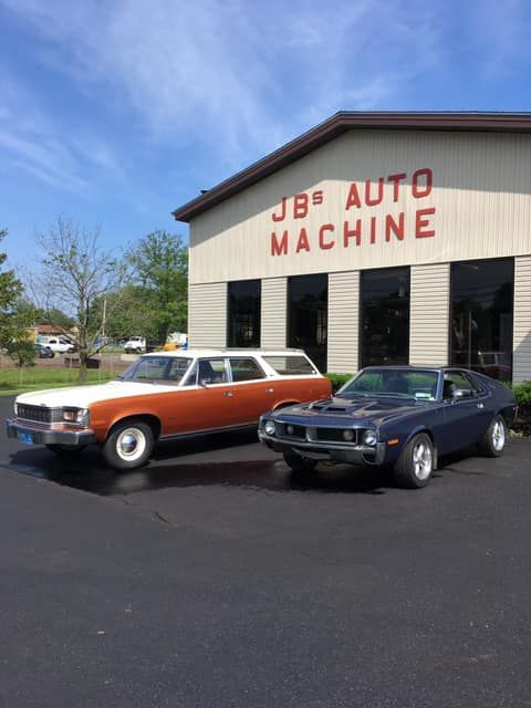 Two classic cars parked in front of 