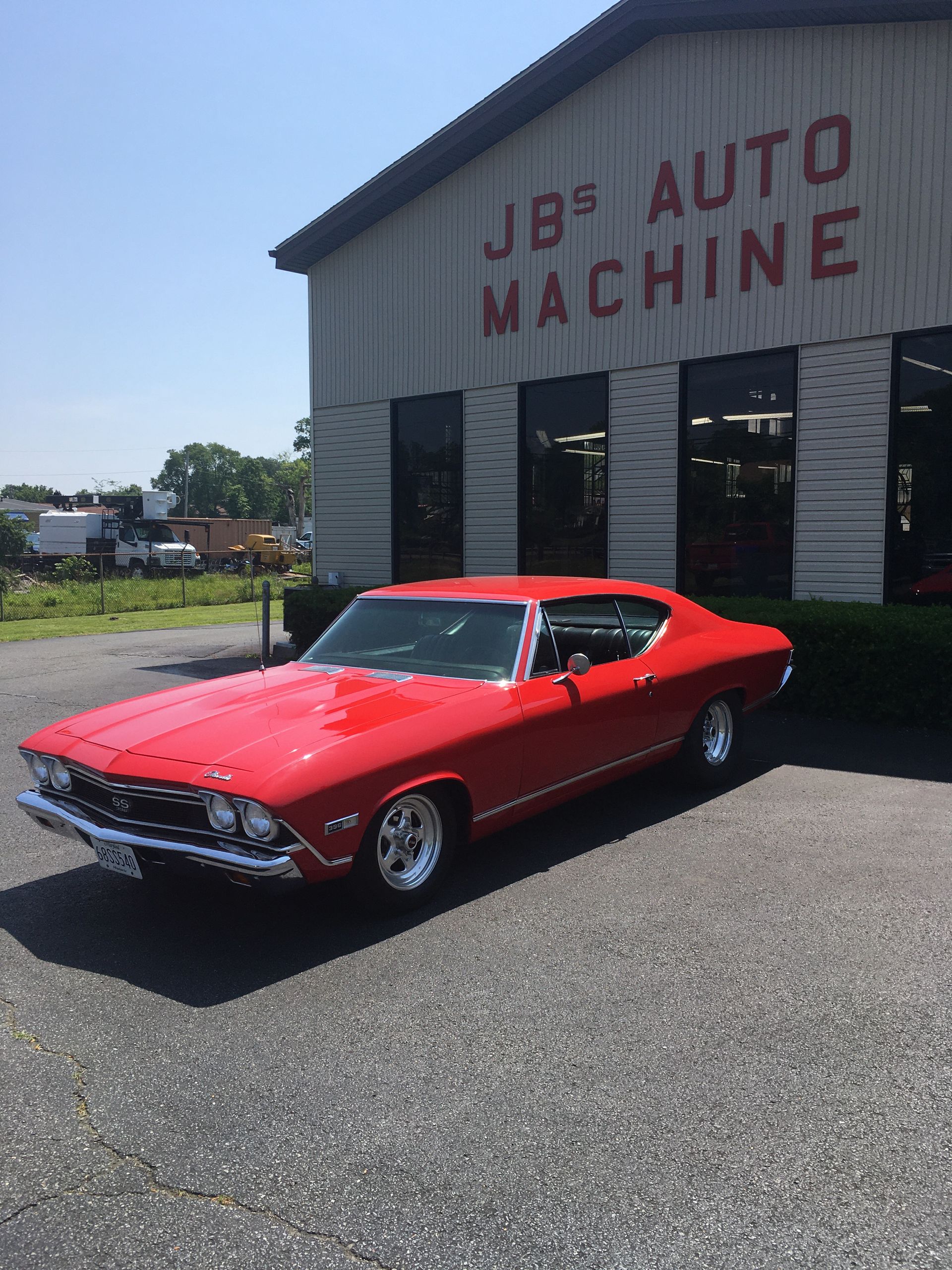 Red classic car parked outside 