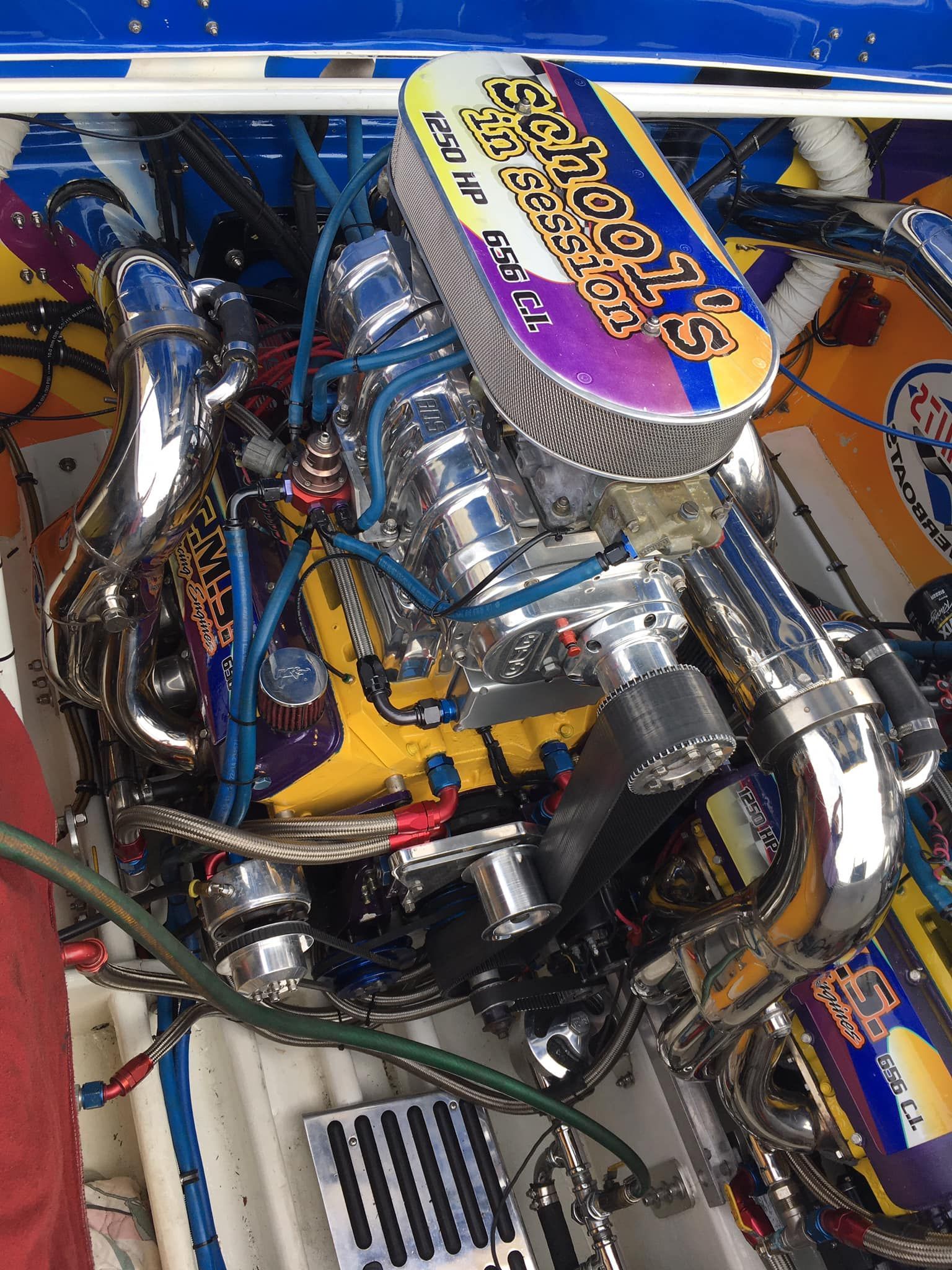 Chrome-covered boat engine with air filter reading 
