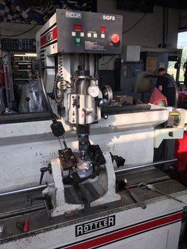 A Rottler engine cylinder head resurfacing machine in use.